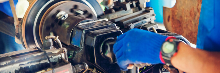Banner Close up Mechanic man hands repairing car auto repair shop. Banner Man hands fixing...