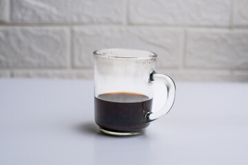 Glass of black coffee isolated on white background
