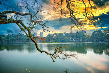 Branch of leaves with Turtle Tower on the foundation of Ho Guom Lake, the center of Hanoi,...