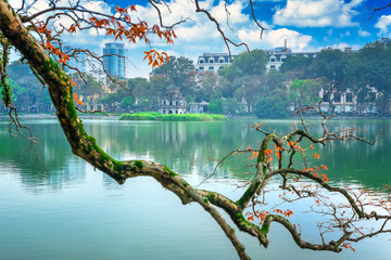 Branch of leaves with Turtle Tower on the foundation of Ho Guom Lake, the center of Hanoi,...