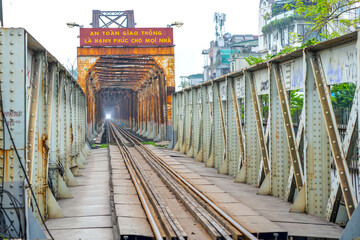 Vintage railroad tracks leading over the famous Long Bien Bridge, Hanoi, Vietnam. This is the...