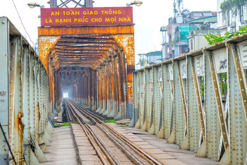 Vintage railroad tracks leading over the famous Long Bien Bridge, Hanoi, Vietnam. This is the...