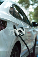 Renewable energy electric car, recharging energy at a charging station.