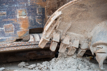 Close up of excavator digger attachment with ground drill head.