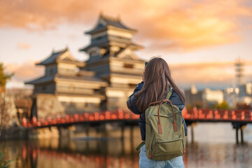Woman tourist Visiting in Matsumoto, happy Traveler taking photo Matsumoto Castle or Crow castle....