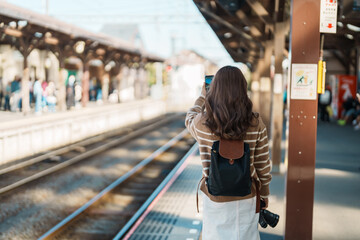 Woman tourist waiting train and Visiting in Kamakura, Kanagawa, Japan. happy Traveler sightseeing...