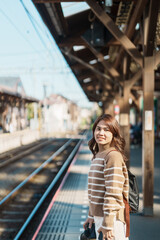 Woman tourist waiting train and Visiting in Kamakura, Kanagawa, Japan. happy Traveler sightseeing...