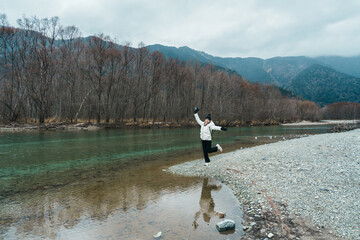 Woman tourist travel Kamikochi National Park, happy Traveler sightseeing Tashiro pond with...