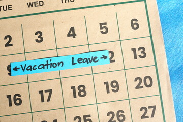 Vacation leave from work concept. Written reminder note on calendar.