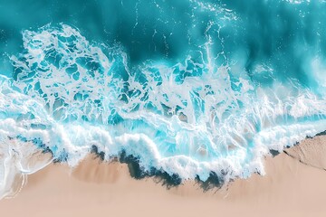 Turquoise ocean waves crash on the sandy beach.