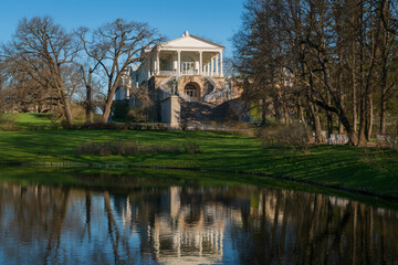 View of the Cameron Gallery on the shore of a large pond in Catherine Park of Tsarskoye Selo on a sunny spring day, Pushkin, St. Petersburg, Russia