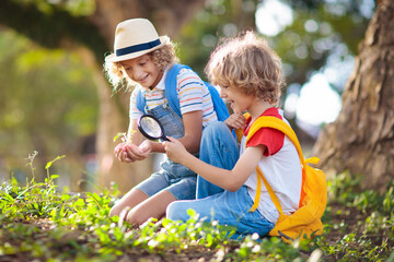 Kids explore nature. Children hike in sunny park.