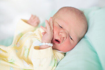 Newborn baby boy in hosptal cot