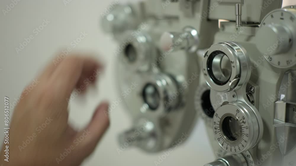 Sticker close up of a person holding a Phoropter eye test 