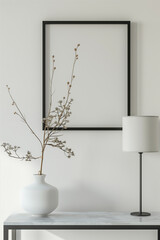 The simulation of a black frame with a white coating contrasts with the plain white wall. and simple furniture,