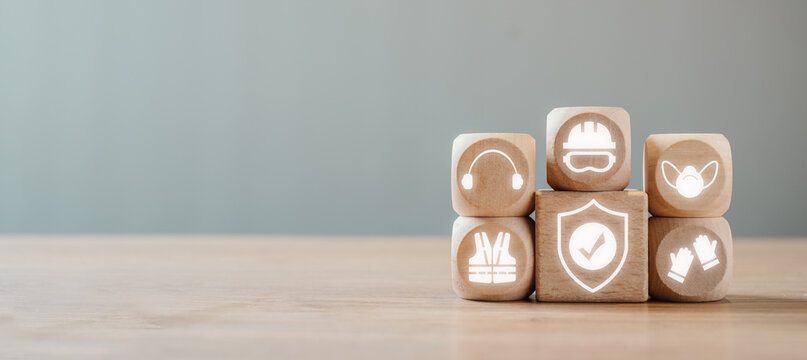 Work safety concept, Wooden block on desk with work safety icon on virtual screen.