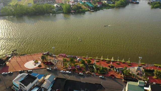 Drone tilting over the city and sea in Surat Thani, sunny morning in Thailand