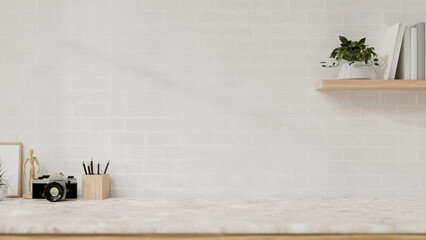 A display space on a white marble table showcases products against the white brick wall.