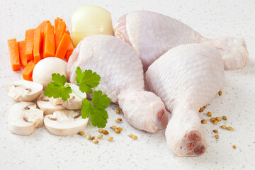 Raw Chicken Drumsticks  - with chicken drumsticks, mushrooms, carrots and parsley.
