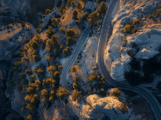 Aerial view of a winding mountain road in the French Alps, creating an abstract pattern with its curves and turns.