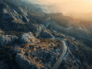 Aerial view of a winding mountain road in the French Alps, creating an abstract pattern with its curves and turns.