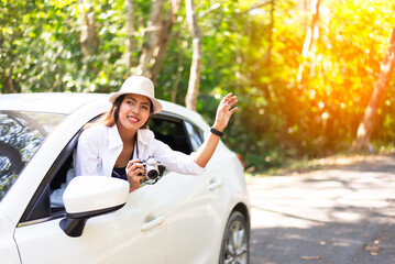 Asian women travel relax in the holiday. Traveling by car park. happily With nature, rural forest. In the summer