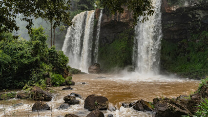 Beautiful tropical waterfalls fall from the cliff into the river. Splashes. picturesque boulders in...