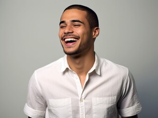Obraz premium A smiling man in a white shirt is sitting on a blue background