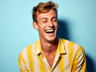 Obraz premium A man with a yellow shirt is smiling and laughing