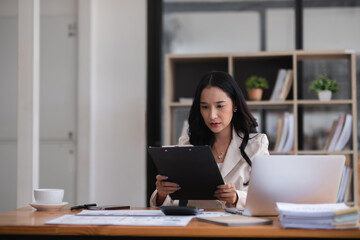 Young businesswoman has problems with her work in the office Feeling stressed and unhappy, showing a serious expression