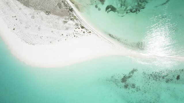 Cayo de agua in los roques with turquoise waters and white sandy beach, aerial view
