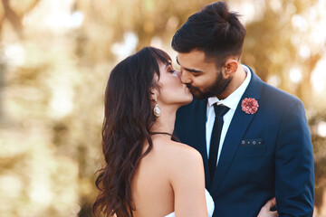 Wedding, kiss and couple with love at sunset in celebration of marriage and happiness. Bride, groom and people show care and support in romantic commitment with luxury countryside event in summer