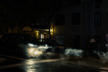 Cars with their Headlights Covered in Smoke at Night - Midtown Manhattan, New York City