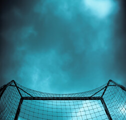 silhouette of a soccer goal from below and behind, with copy space