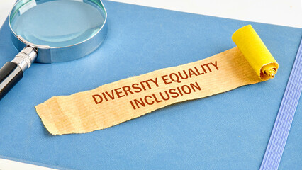 Business concept. Words DEI, diversity, equity, inclusion on a note made of paper on a blue...