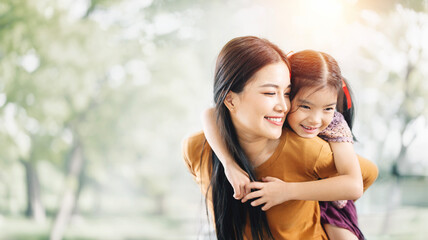 Happy asian mother having fun with her daughter outdoor - Family and love concept