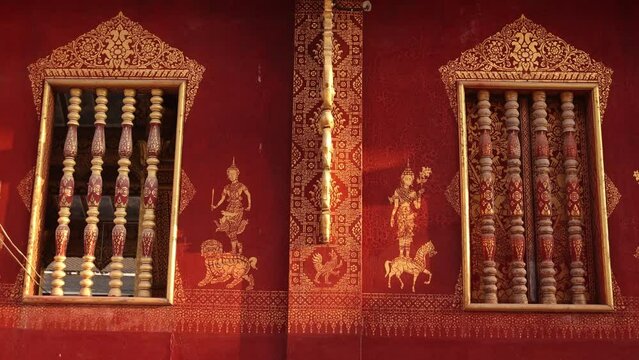 red and gold art work on buddhist temple in Luang Prabang, Laos traveling Southeast Asia