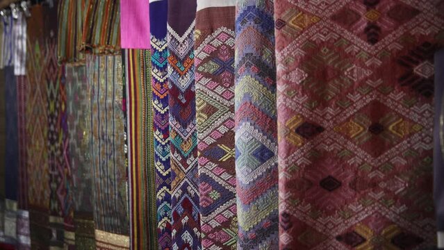 colorful fabrics for sale at night market in Luang Prabang, Laos traveling Southeast Asia