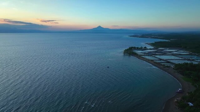Aerial wide shot of Matutum stratovolcano at sunrise near General Santos Town, Philippines. 
