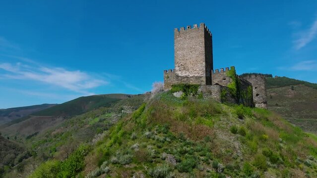 Castelo de Doiras - Medieval Fortress On Hill In Cervantes, Lugo, Spain. low angle, orbiting shot