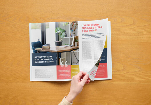 Mockup of person turning page of customizable A4 magazine