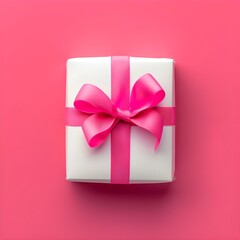 white gift box with a pink ribbon and bow, placed against a vibrant pink background