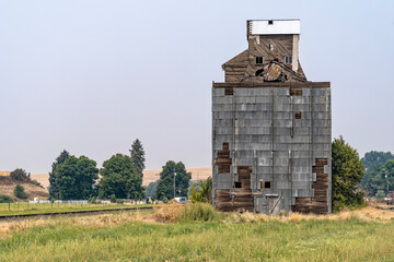 Sections of metal siding have fallen off an abandoned grain elevator in southeastern Washington, USA