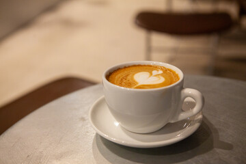 This is cafe latte coffee with latte art drawn on it.