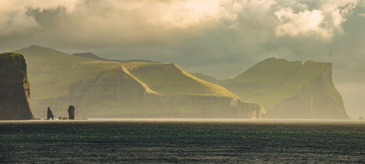 Faroe Islands, Eysturoy island. Panoramic with gorgeous sunset over Risin og Kellingin rock...