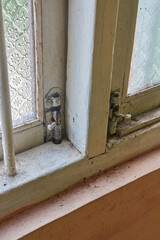 old dirty wooden glass windows with tower bolt hinge and lock installed, close-up with copy space
