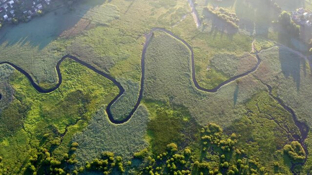 4K aerial - a bird's eye view&nbsp;video (Ultra High Definition) of looded valley. Misty morning scene of snake shape Seret river. Misty summer view of Ternopil countryside, Ukraine, Europe.