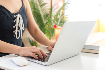 Woman using computer working in internet at cafe