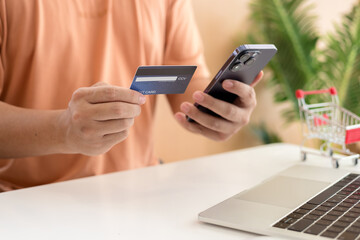 Online payment,Man's hands holding a credit card and using smart phone for online shopping