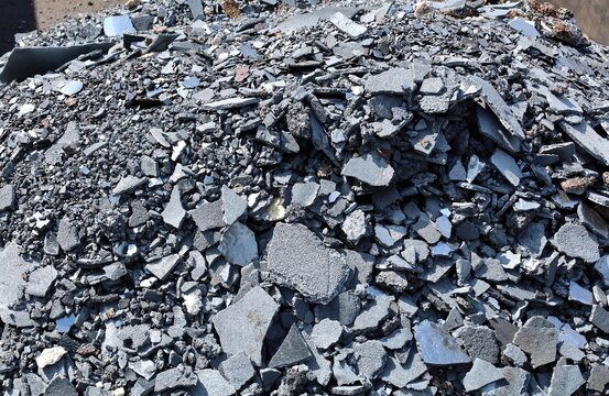 Heap of steel slags and iron lumps from metallurgical industry ready for recycling. Background and texture.